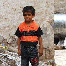 Yemen boy in orange striped shirt