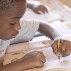 Mozambican child learning to write.