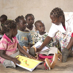 Marcela Domingos teaching Mozambican children in classroom.