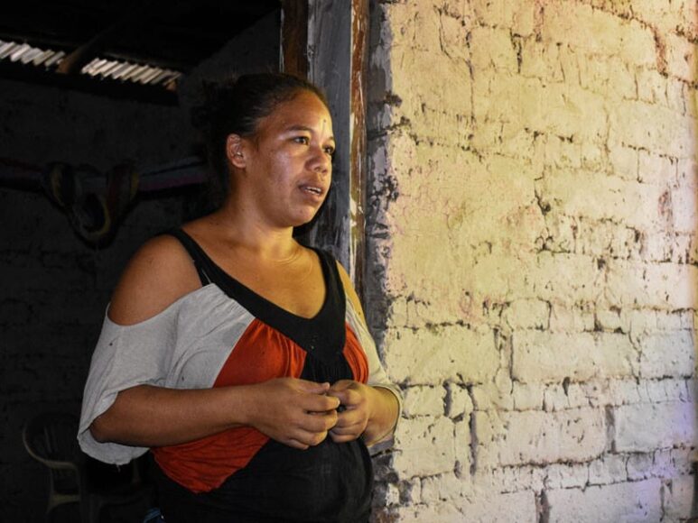 Petronila Carcamo in the doorway of her home in Honduras.