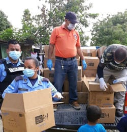 Law enforcement and community leaders help provide relief to residents in Rivera Hernandez, San Pedro Sula.