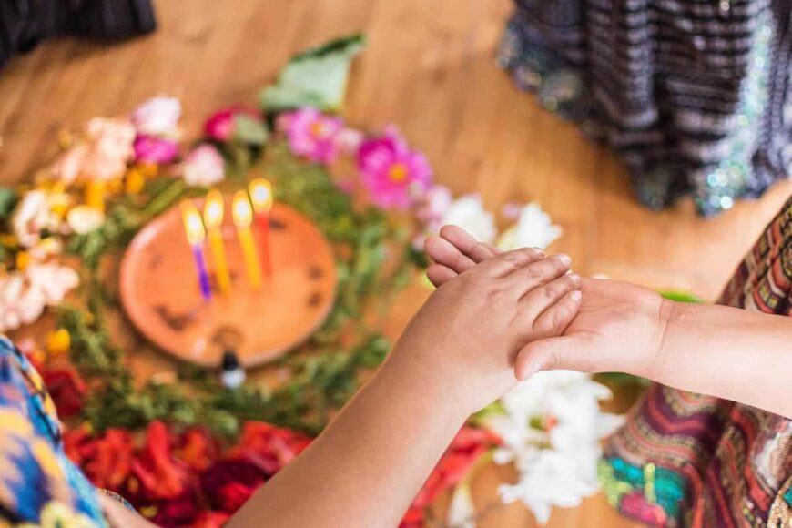 Women holding hands during a ceremony